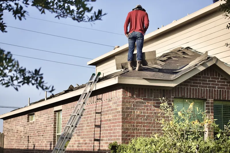 Professional roofer working on a residential roof in South Elmhurst